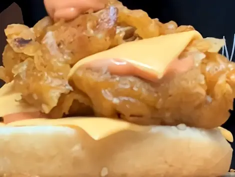 Step 8: Add more sauce to the top bun, close