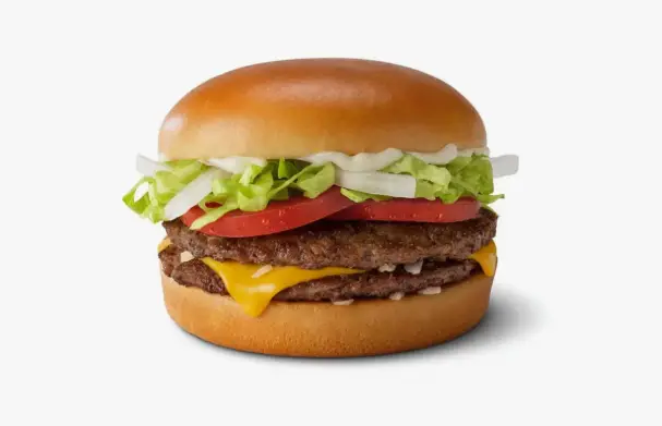 Close-up of a beef patty with melted American cheese in a soft burger bun