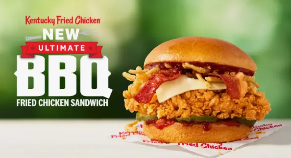 Close-up of a breaded chicken fillet with pickles in a brioche bun