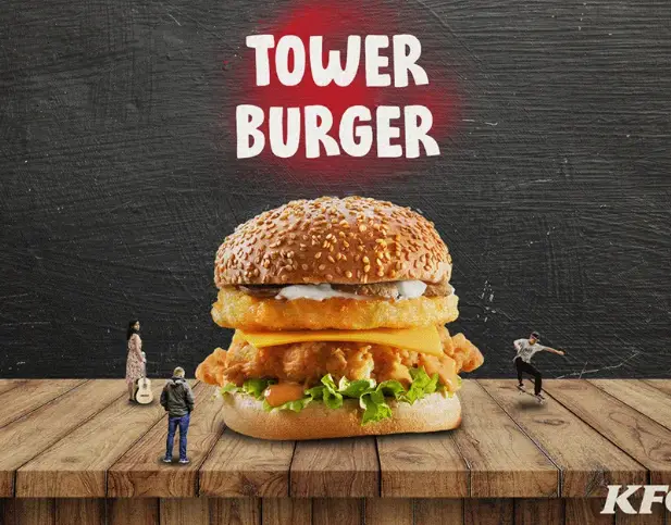 Close-up of a breaded chicken fillet with melted cheddar in a soft burger bun