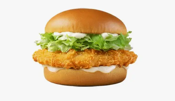 Close-up of a chicken patty with a fried egg in a sesame seed bun