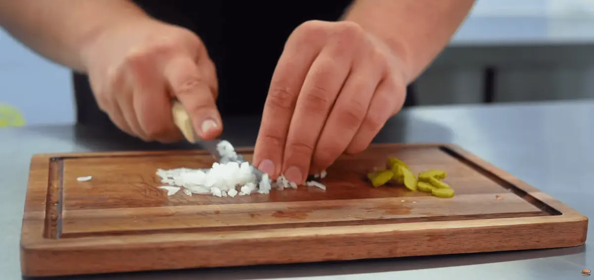 Step 1: First, prep the signature 'slivered' onions. Instead of
