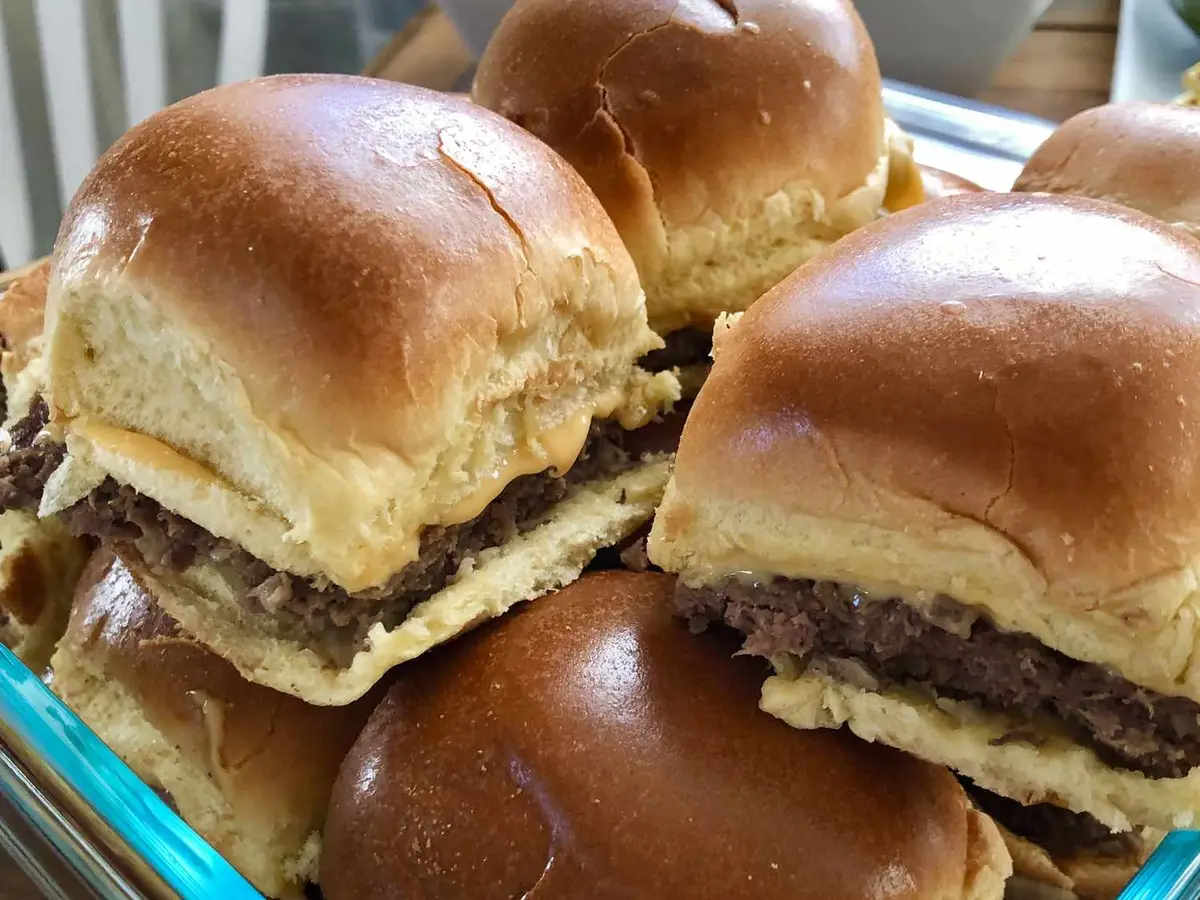 Close-up of a beef patty with a fried egg in a slider roll