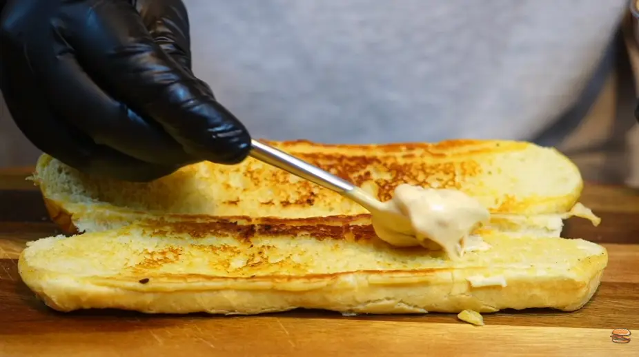 Step 6: Spread sauce on both sides of the baguette.
