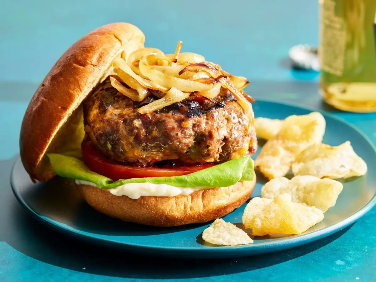 Close-up of a beef patty with Colby Jack and diced onion