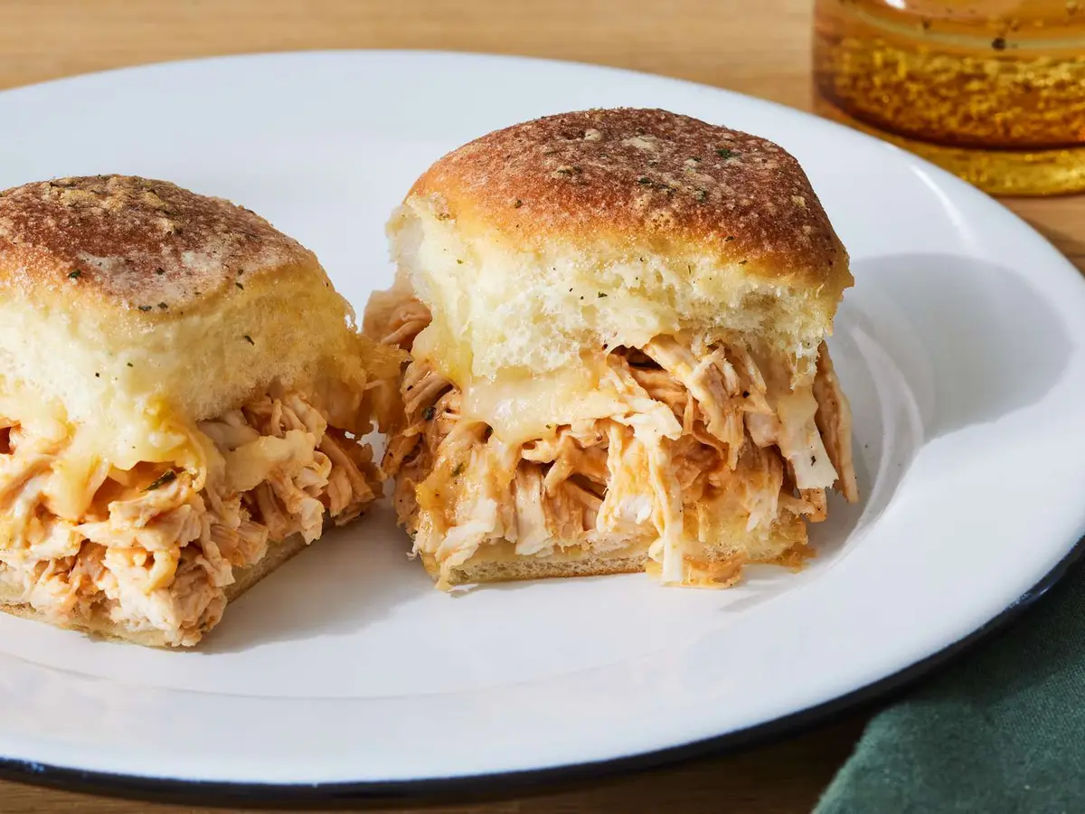 Close-up of a breaded chicken fillet with Monterey Jack in a slider roll