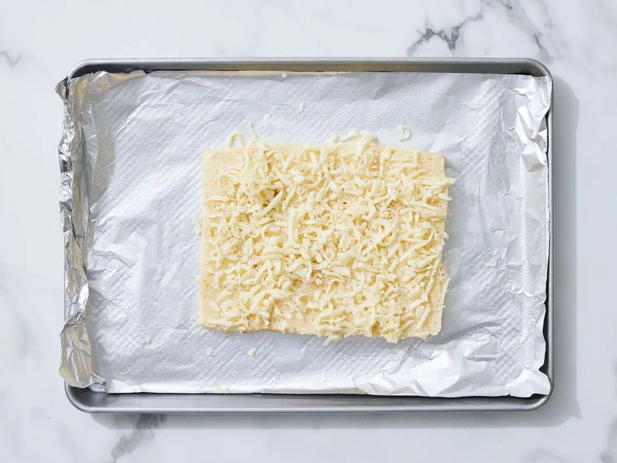 Step 3: Scatter 3/4 cup of the cheese over the
