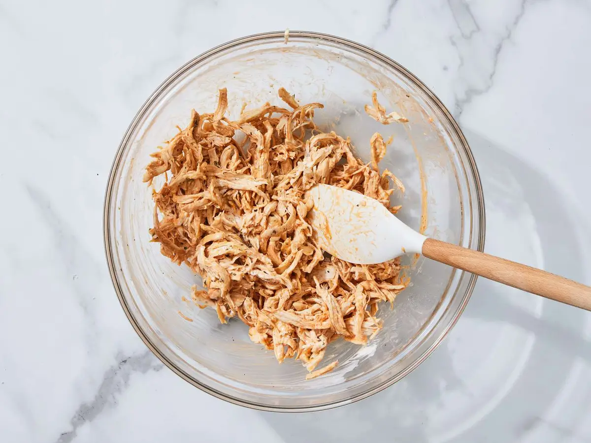 Step 4: In a large bowl, toss the warm chicken