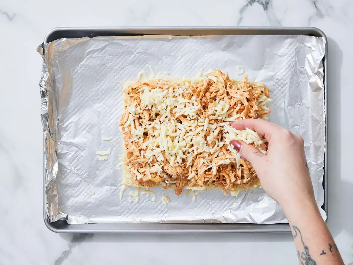Step 5: Spread the chicken over the rolls and scatter