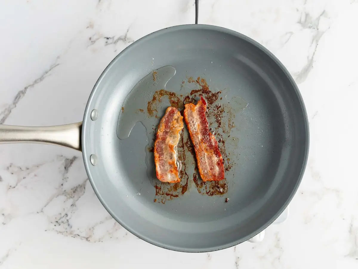 Step 2: Lay the bacon in a large skillet while