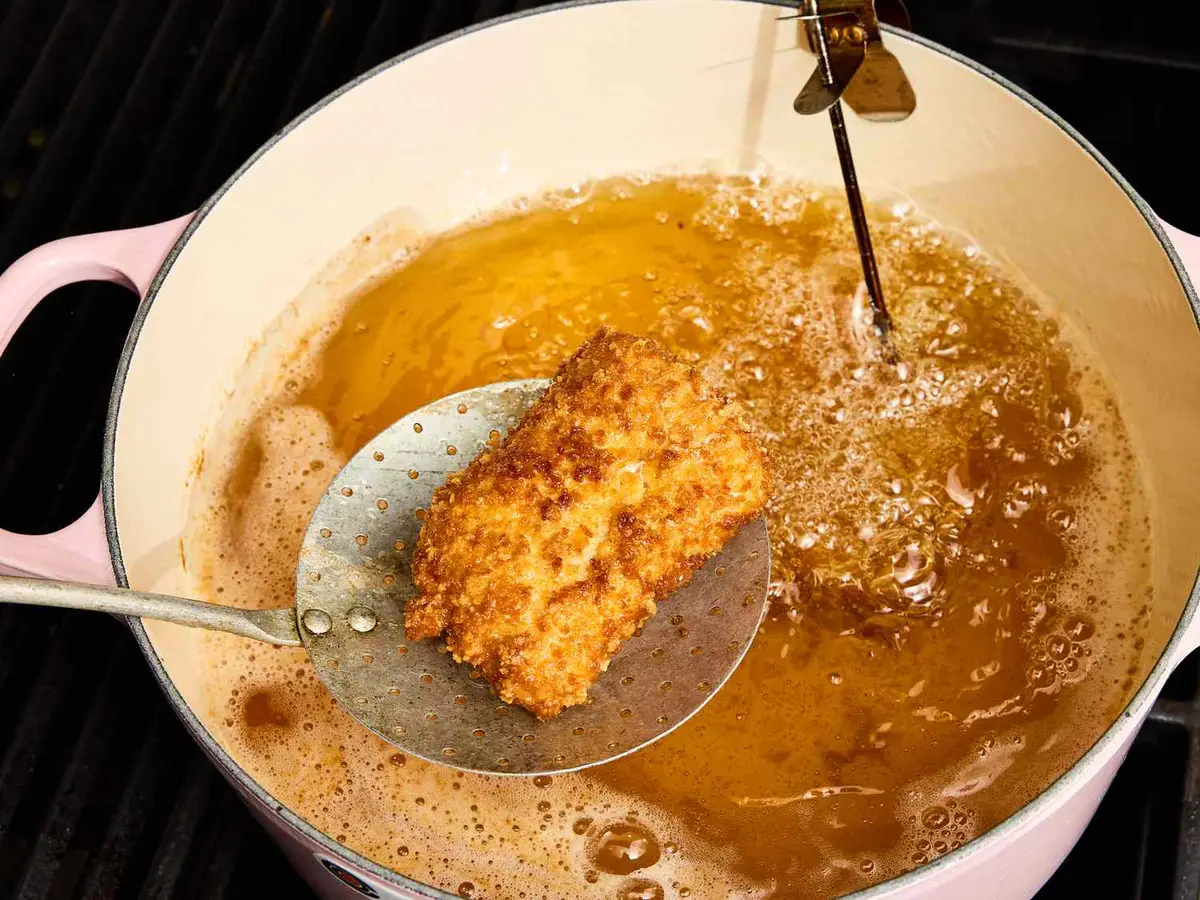 Step 3: Lower 2 fillets gently into the oil and
