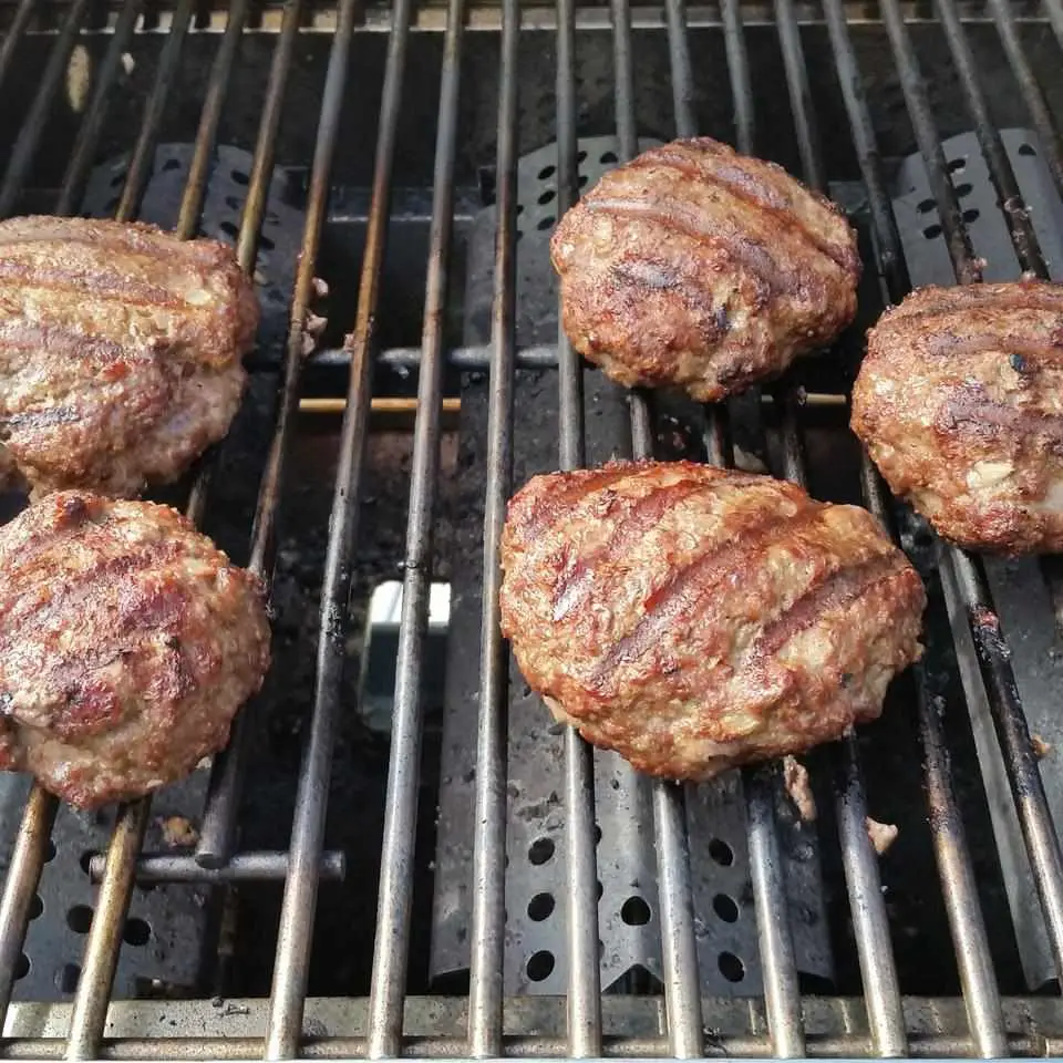 Close-up of a bison patty with melted American cheese in a soft burger bun