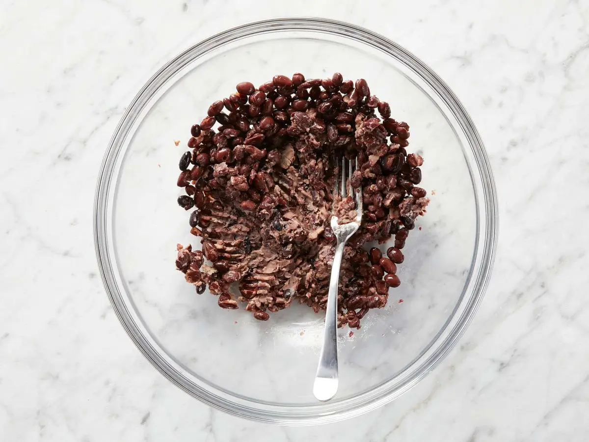 Step 2: In a medium bowl, mash the black beans