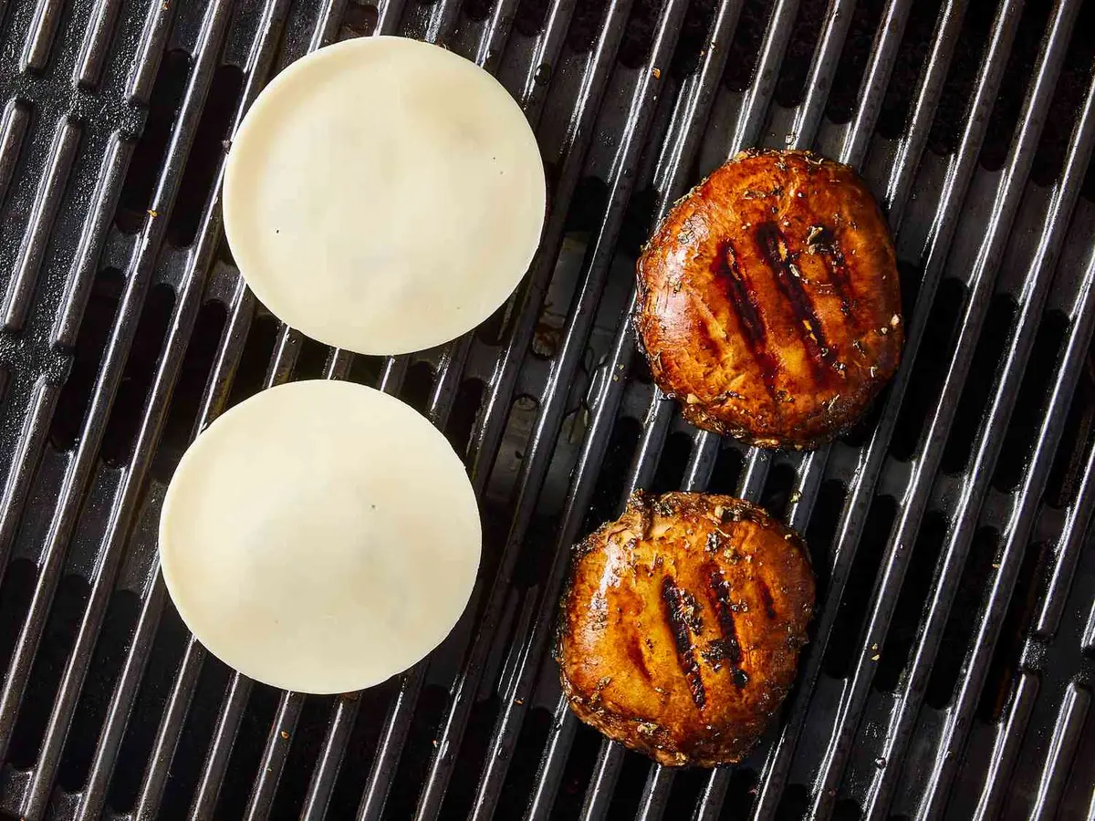 Step 7: Lay the cheese on top of the mushrooms.