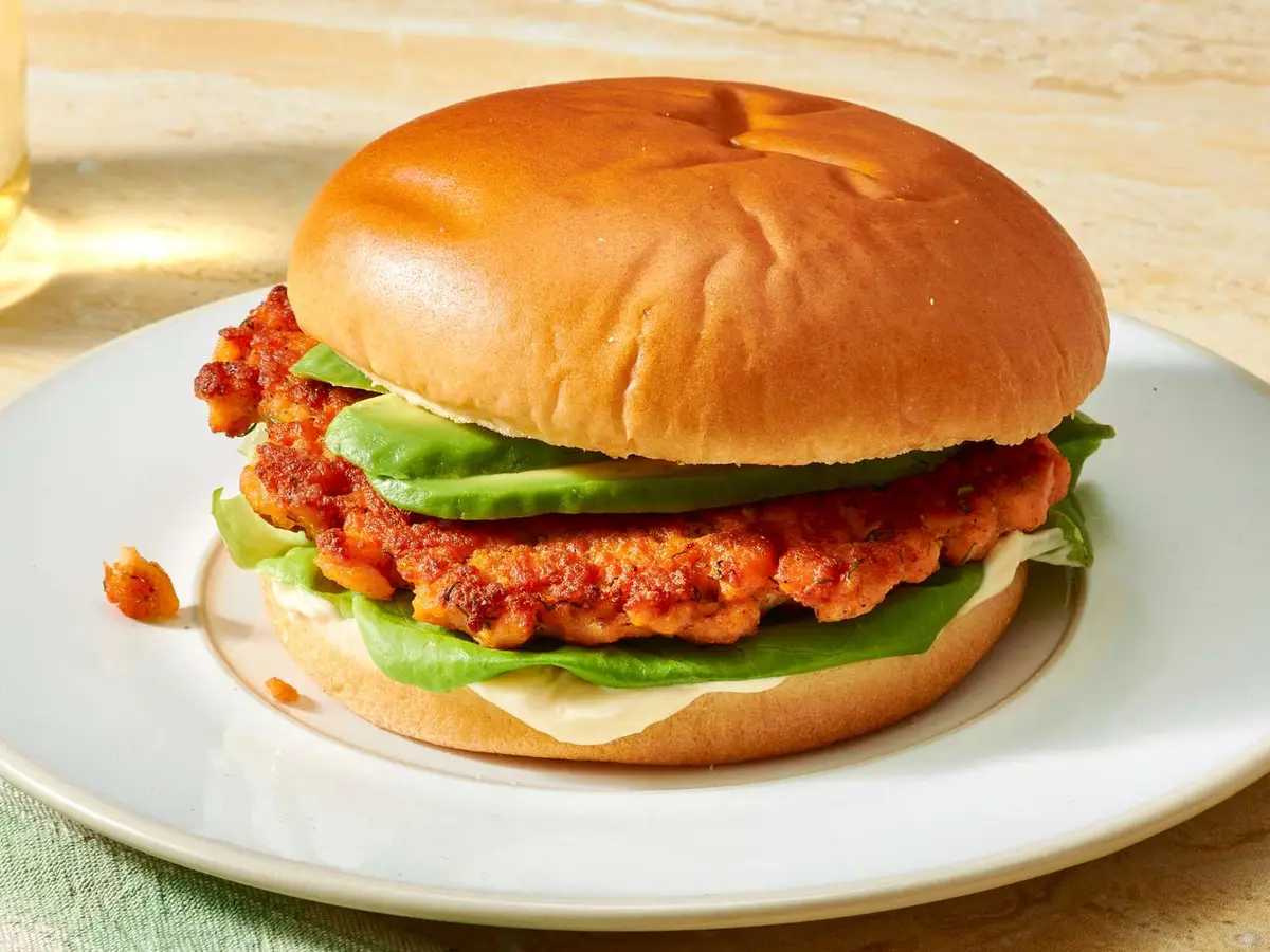 Close-up of a salmon patty with a fried egg served open