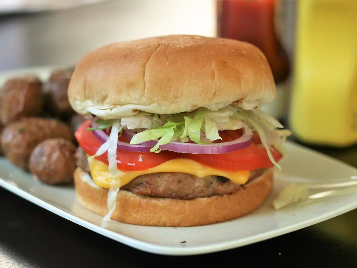 Close-up of a turkey patty with a fried egg in a soft burger bun