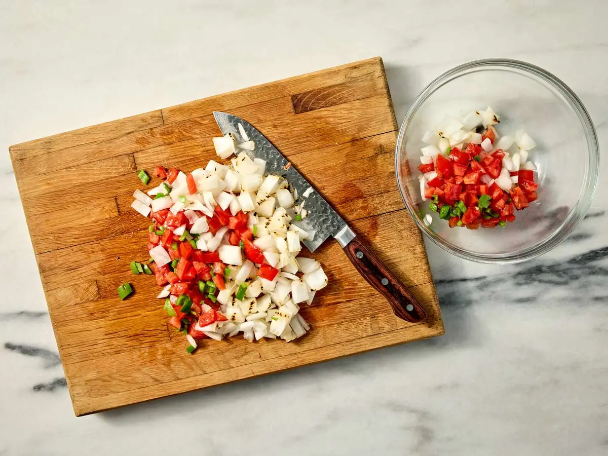 Step 3: Chop the tomatoes and onion finely. Seed the