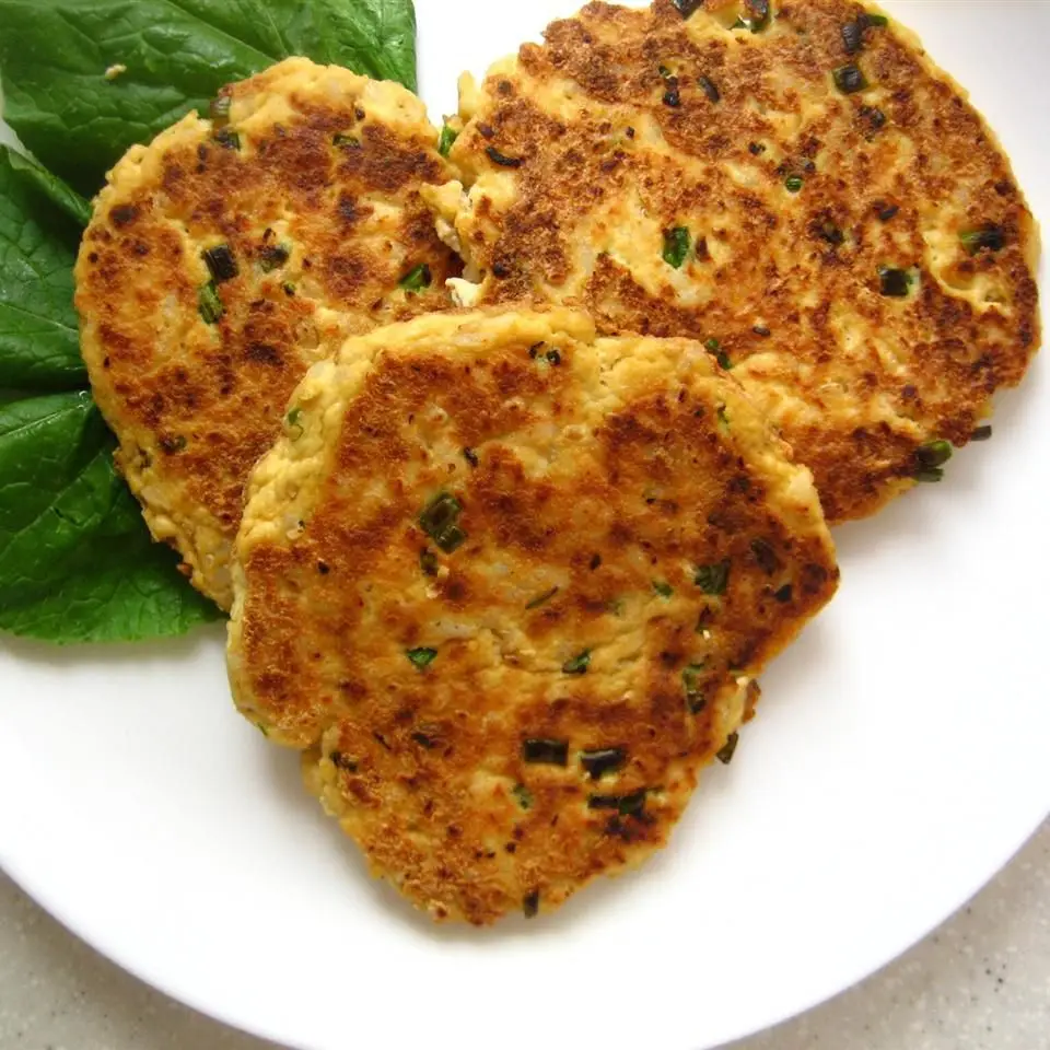 Close-up of a tofu patty with melted cheddar and diced onion