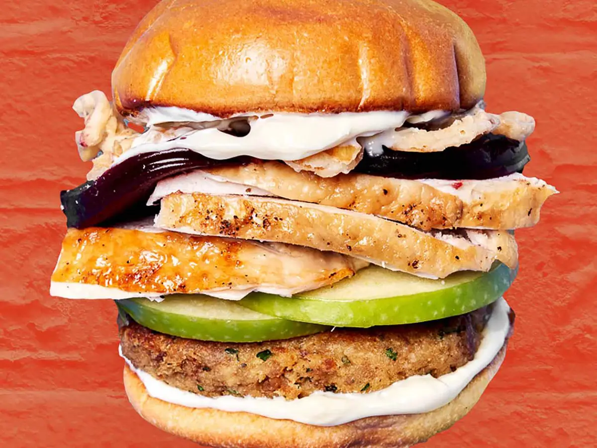Close-up of a burger patty with a fried egg in a soft burger bun
