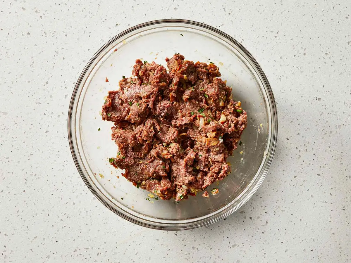 Step 6: Mix the venison into the cooled bacon mixture